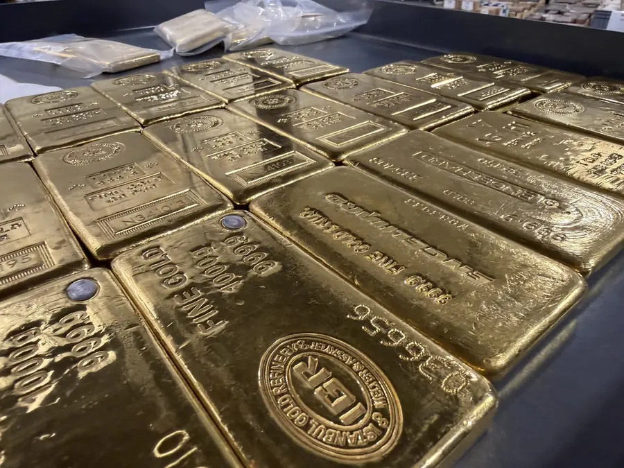 Rows of gold bullion bars stored in an insured depository vault